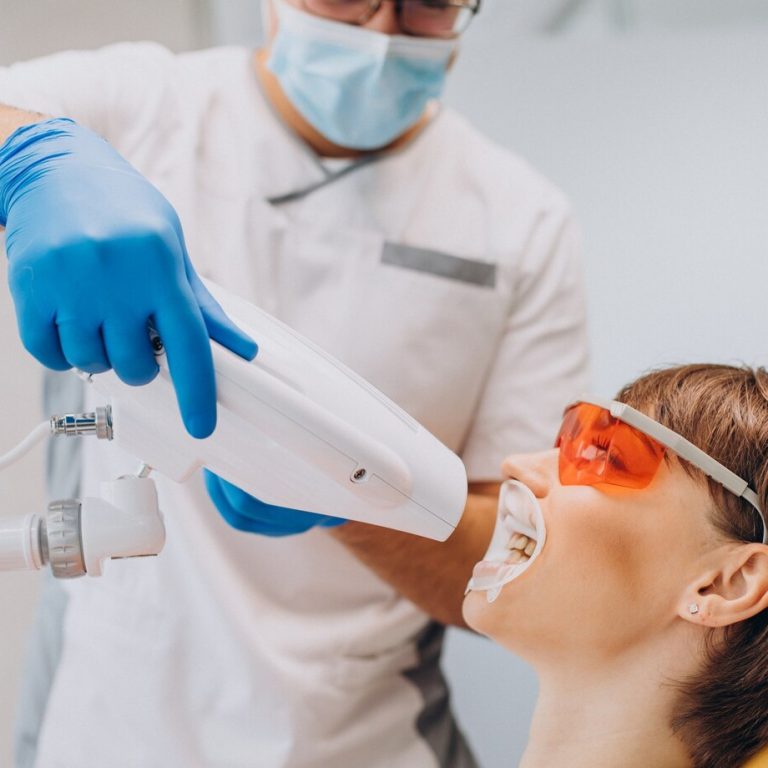 woman-whitening-teeth-dentistry-with-special-equipment_1303-26400